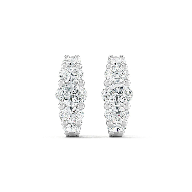 Oval diamond hoop earrings in white gold by Stellini Diamonds, showcasing sparkling diamonds in an elegant design.