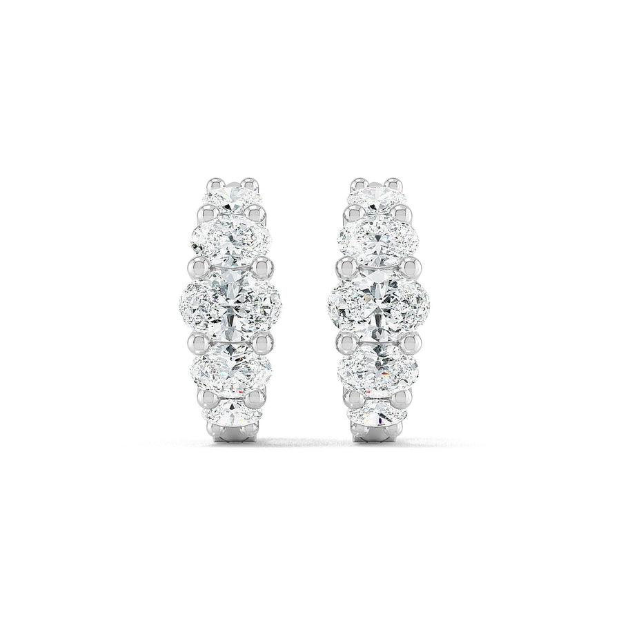 Oval diamond hoop earrings in white gold by Stellini Diamonds, showcasing sparkling diamonds in an elegant design.